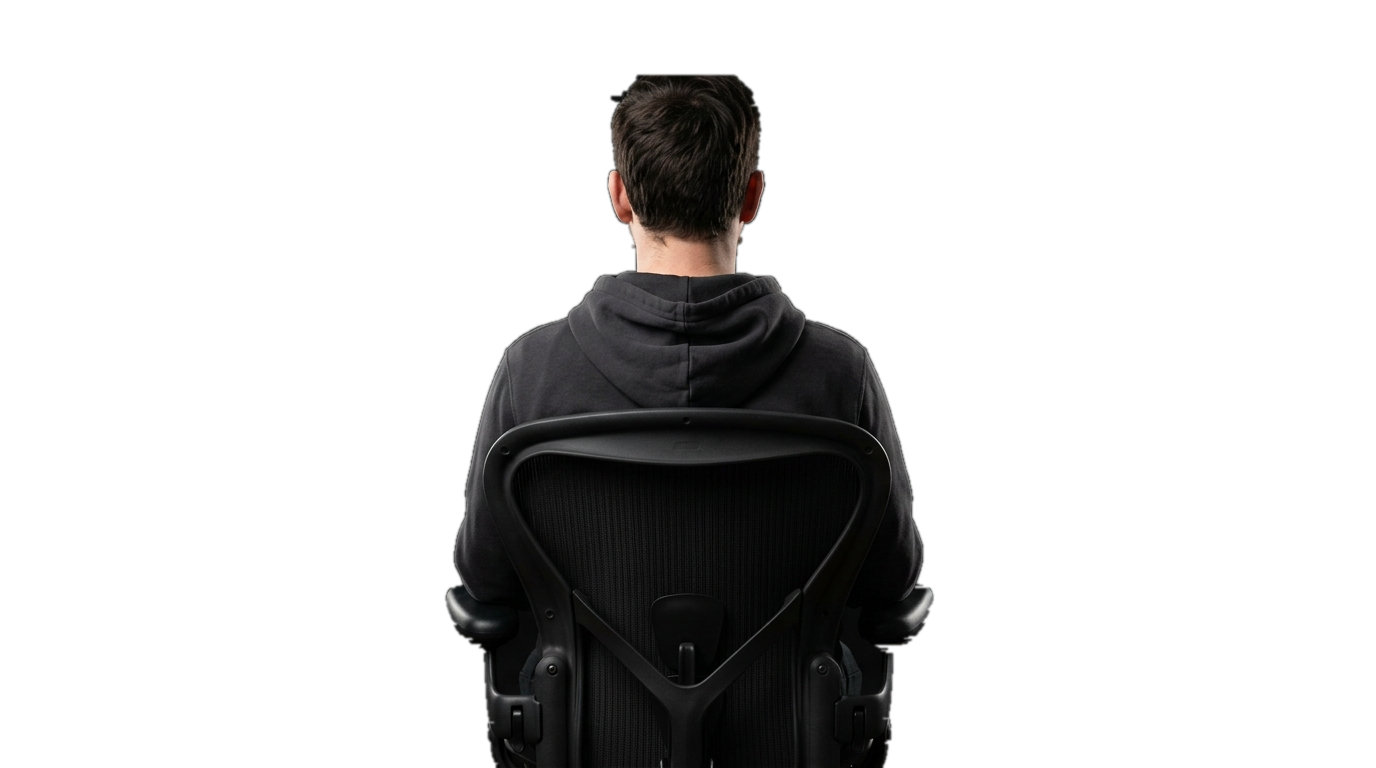 Male Developer Seated in Ergonomic Chair from Behind